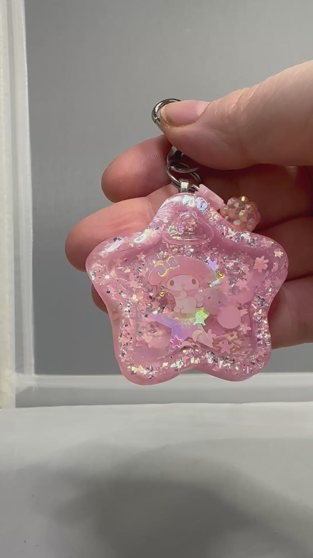 Star Liquid Shaker Keychain - hand to mouth